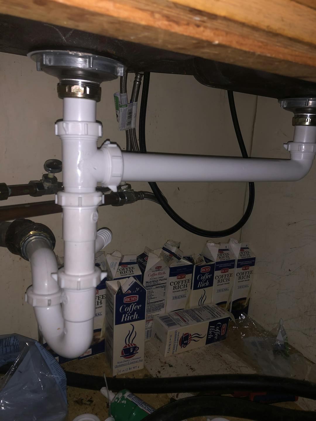 Brand new installed Vinyl plumbing pipe under a dual kitchen sink